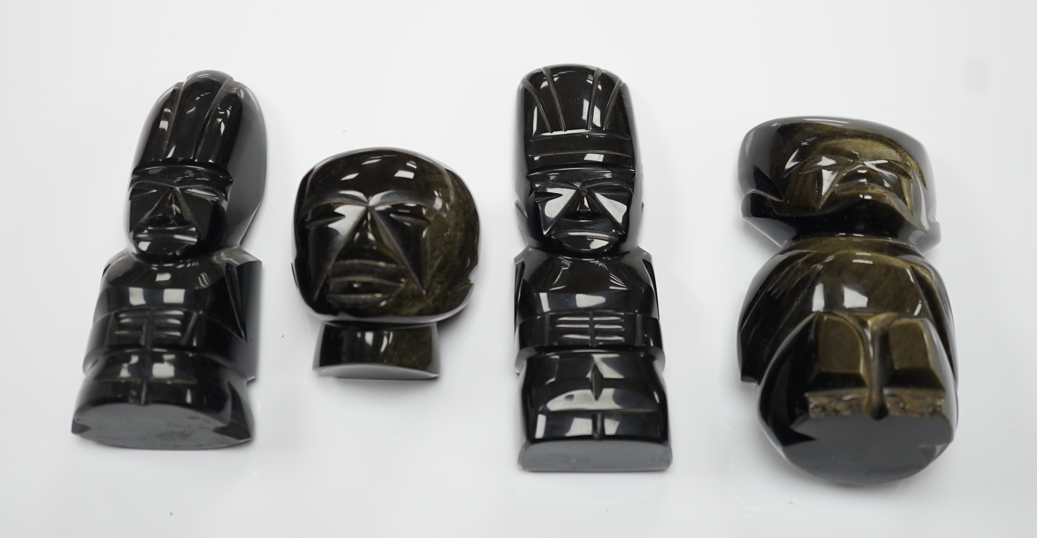 Three 20th century Aztec Mayan style carved obsidian stylised figures and a similar mask (4) tallest 15cm